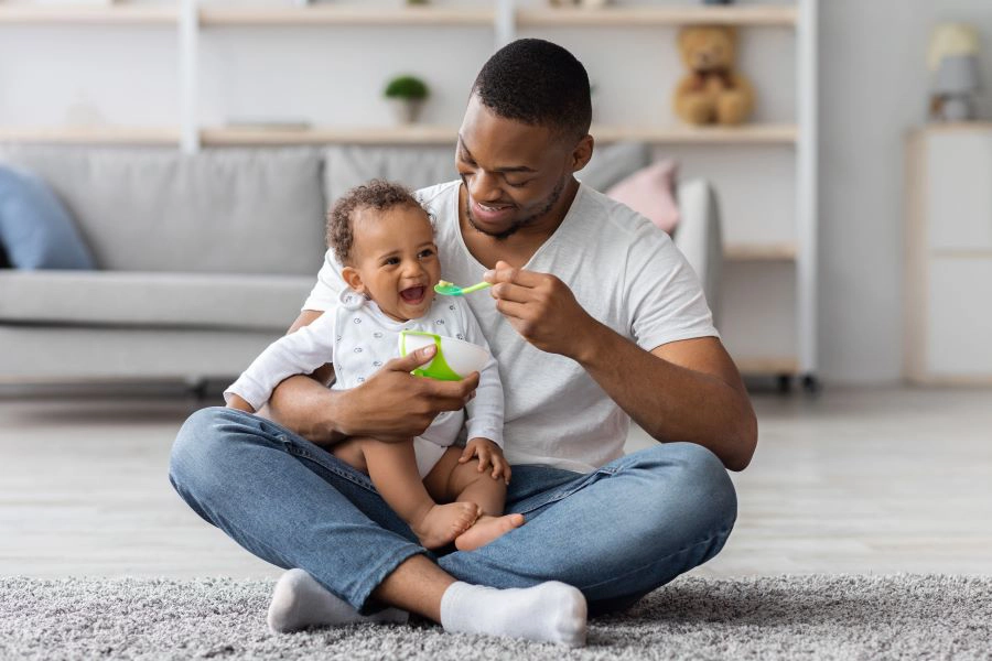 Father feeding infant